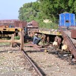 Railway workers are busy welding while repairing a goods train at Kotri Railway Workshop