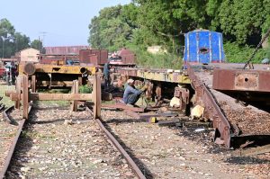 Railway workers are busy welding while repairing a goods train at Kotri Railway Workshop