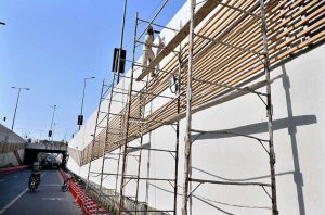 Labourers paint the side wall of the Abdul Sattar Edhi Underpass on Ferozepur Road opposite Gulab Devi Hospital to enhance its appearance and beautify the provincial capital.