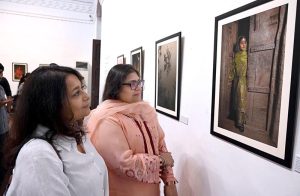 A visitor shows her keen interest in the photographs displayed at the exhibition 'The Too-Young Monsoon Brides' by French photographer Isabeau de Rouffignac at the Zahoor-ul-Akhlaq Art Gallery. The exhibition was organized by Alliance Française Lahore in collaboration with the French Embassy in Pakistan and the National College of Arts