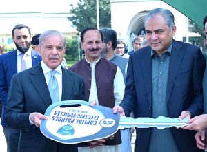 Prime Minister Muhammad Shehbaz Sharif presenting keys of 50 environmental friendly Electric Vehicles to Federal Minister for Interior Moshin Naqvi; the EVs will be a part of "Capital Patrol", an initiative of Islamabad Capital Territory Police.