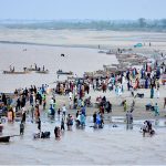 Following heavy monsoon rains across the country, the rise in water levels in the Indus River has drawn people to the riverbanks, where they are spending time with their families