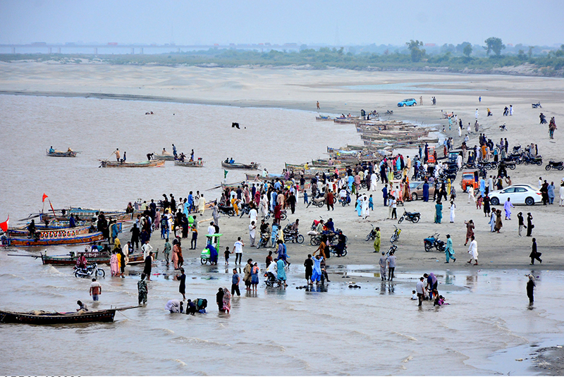 Following heavy monsoon rains across the country, the rise in water levels in the Indus River has drawn people to the riverbanks, where they are spending time with their families