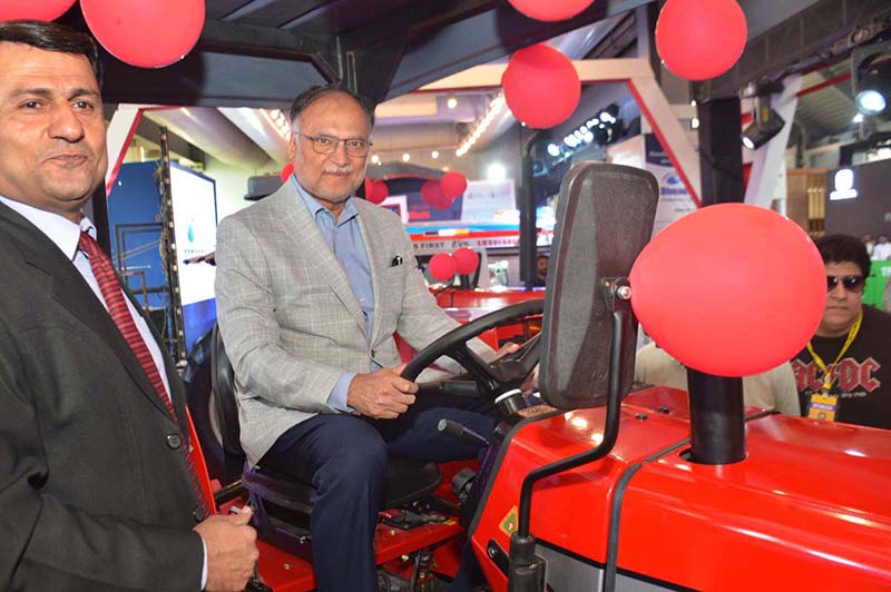 Federal Minister for Planning, Development and Special Initiatives Ahsan Iqbal inspects a tractor during the Pakistan International Auto Show 2026, organized by the Pakistan Association of Automotive Parts & Accessories Manufacturers at the Expo Centre