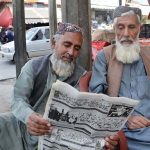 Elderly men read an Urdu newspaper to stay informed about current affairs and local,International, national and political issues at Liaquat Bazaar