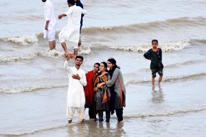 Following heavy monsoon rains across the country, the rise in water levels in the Indus River has drawn people to the riverbanks, where they are spending time with their families