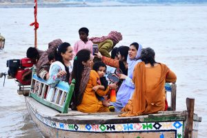 Following heavy monsoon rains across the country, the rise in water levels in the Indus River has drawn people to the riverbanks, where they are spending time with their families