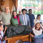 Commissioner Karachi Syed Hassan Naqvi and Federal Secretary for Inter-Provincial Coordination and President Pakistan Hockey Federation Mohyuddin Ahmad Wani, along with others, distribute hockey kits among representatives of 74 selected schools of Karachi Division at NJV School and College on M.A. Jinnah Road