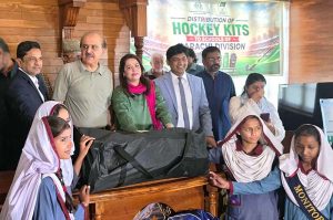 Commissioner Karachi Syed Hassan Naqvi and Federal Secretary for Inter-Provincial Coordination and President Pakistan Hockey Federation Mohyuddin Ahmad Wani, along with others, distribute hockey kits among representatives of 74 selected schools of Karachi Division at NJV School and College on M.A. Jinnah Road