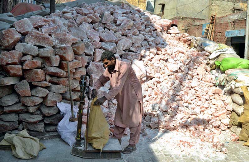 Labourer Weighs and Packs Salt Blocks at Bamboo Market Factory