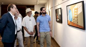 Chief guest and Arts Council President Muhammad Ahmed Shah views artworks at the inauguration of “Unspoken Spaces,” an exhibition featuring works by artist Karam Aspal, at Art City Gallery