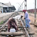 Railway workers repair tracks at the railway station to ensure safe train operations and prevent mishaps