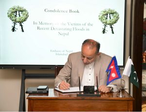 Dr Musadik Malik records his heartfelt condolences for the victims of the devastating floods in Nepal in the book of remembrance