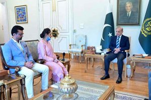 Prime Minister Muhammad Shehbaz Sharif hands over a cheque of reward of 1 Crore to Ms. Razia Naureen, a nurse of PIMS Islamabad, who saved life of a child during an unfortunate incident at NICU of the PIMS.