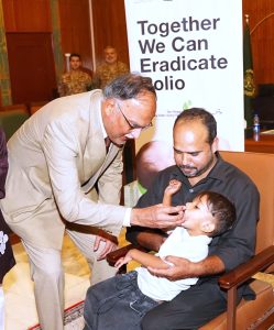 Federal Minister for Planning, Development and Special Initiatives Ahsan Iqbal administers polio drops to a child during the meeting of the Prime Minister’s Committee on the National Taskforce for Polio Eradication, chaired by him