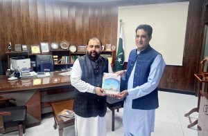 Executive Director of the National Language Promotion Department, Dr. Rashid Hameed presenting his authored books to Federal Minister for National Heritage & Culture Aurangzeb Khan Khichi.