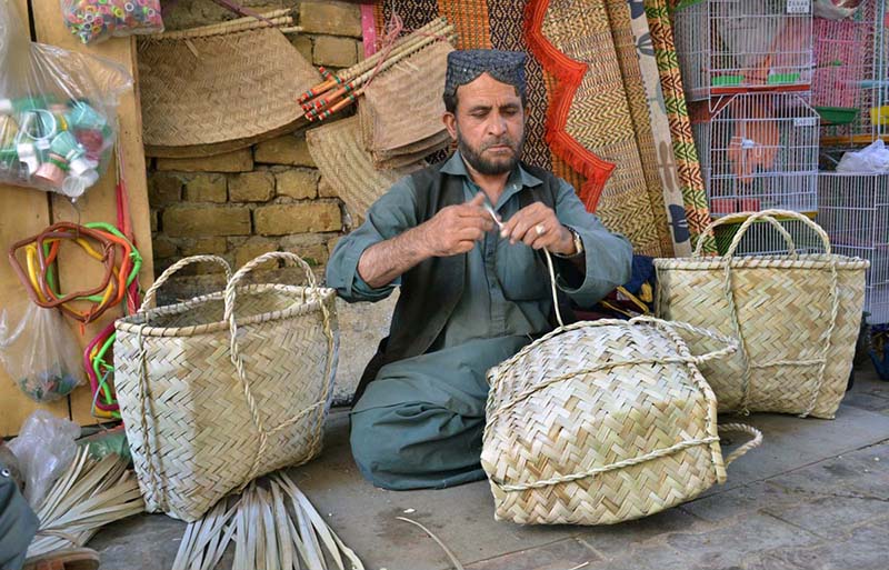 Pakistani Artisan Hand-Weaves Baskets and Fans From Dried Date Palm Leaves