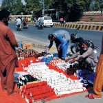 Customers purchase tea cups at affordable prices from a roadside stall in the city