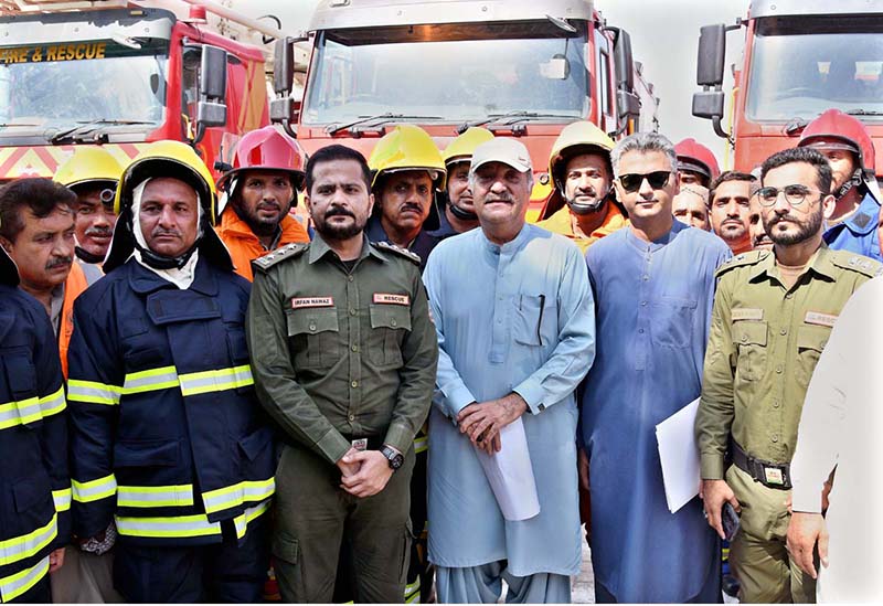 Political Secretary to PPP Chairman and MPA Jameel Ahmed Soomro poses for a group photo with Larkana Mayor Adv. Anwar Ali Luhar and fire brigade staff after handing over three fire brigade vehicles provided by the Sindh Government during a ceremony at the Municipal Stadium