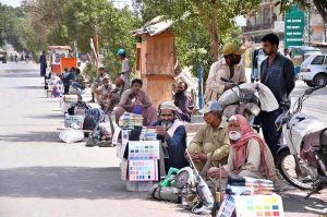 Daily wage workers having their tools, waiting for job at Latifabad Chowk