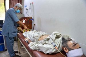 A healthcare professional conducts an electrocardiogram (ECG) test on a patient at the Lady Reading Hospital during World Heart Day