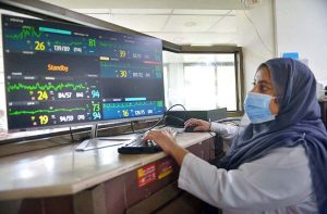 A healthcare professional conducts an electrocardiogram (ECG) test on a patient at the Lady Reading Hospital during World Heart Day