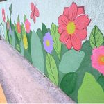 An artist paints the wall of Muslim town under pass canal road during the development and beauty work in the city