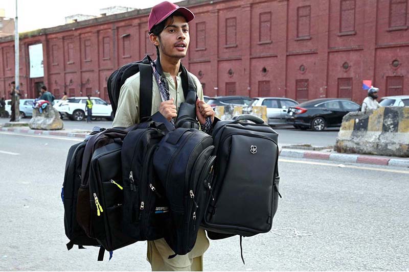 Street vendor displaying bags to attract the customers while shuttling on the road in Provincial Capital