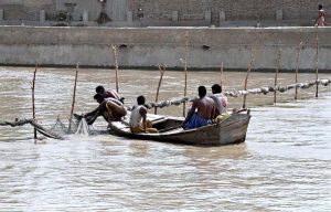 Fisherman preparing net to fish in Rice Canal.