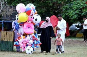 A family purchasing balloon for kid during visiting Historical Frere Hall Attach Bagh-e-Jinnah.