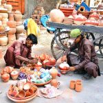 Workers are busy coloring the clay-made pots for selling at Kumhar Para