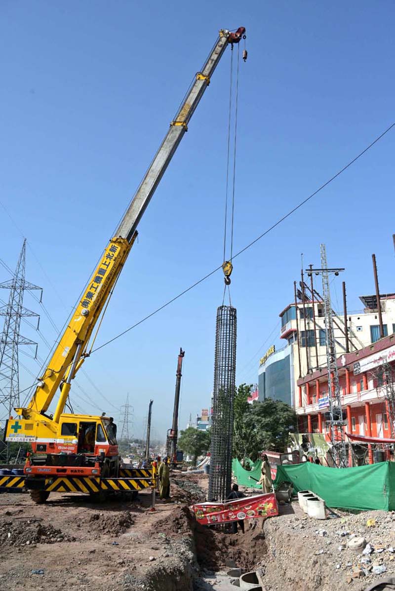 Labourers are busy with their work on the rehabilitation and widening of the Service Road (East) along the Islamabad Expressway, stretching 8.5 to 9 kilometers from Faizabad Interchange to Gulberg Greens