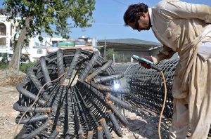 Labourers are busy with their work on the rehabilitation and widening of the Service Road (East) along the Islamabad Expressway, stretching 8.5 to 9 kilometers from Faizabad Interchange to Gulberg Greens