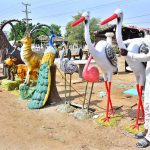 A vendor displaying decorative statues of different animals and birds to attract the customers at Qasimabad