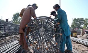 Labourers are busy with their work on the rehabilitation and widening of the Service Road (East) along the Islamabad Expressway, stretching 8.5 to 9 kilometers from Faizabad Interchange to Gulberg Greens