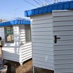 A painter gives the finishing touches to security guards’ cabins at his workshop in the federal capital