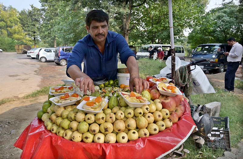 A vendor displaying Guava fruits to attract the customers at his roadside setup in Aabpara
