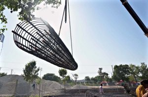 Labourers are busy with their work on the rehabilitation and widening of the Service Road (East) along the Islamabad Expressway, stretching 8.5 to 9 kilometers from Faizabad Interchange to Gulberg Greens