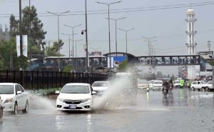 Vehicles passing through rain water accumulated on a University Road following heavy rainfall in the Provincial Capital.