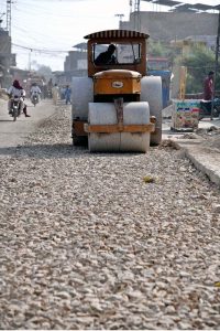 A driver operates a road roller to level a road under construction a part of development project in Baka Pur village.