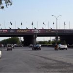A large banner is displayed on Zero Point Bridge in connection with the upcoming Kashmir Black Day on October 27, as traffic flows underneath in the Federal Capital