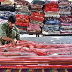 A worker is busy stitching quilt for customers at his workplace G-7 Sector in the Federal Capital