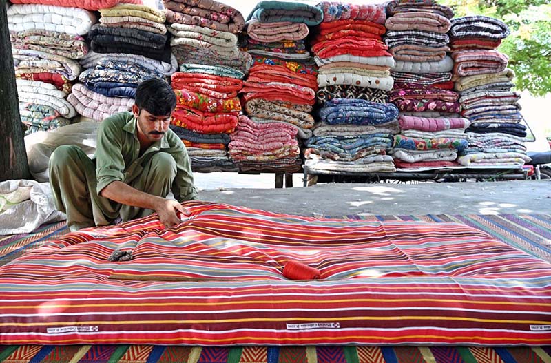 A worker is busy stitching quilt for customers at his workplace G-7 Sector in the Federal Capital