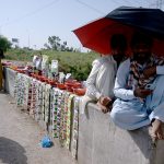 A man sells vegetable and flower seeds along the roadside at Khanna Pul