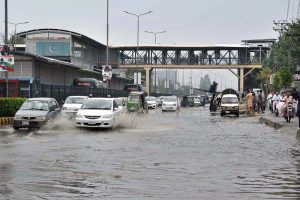 Vehicles passing through rain water accumulated on a University Road following heavy rainfall in the Provincial Capital.