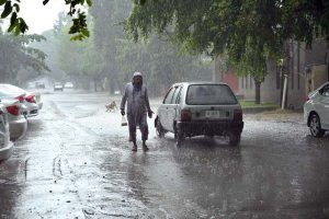 Vehicles passing through rain water accumulated on a University Road following heavy rainfall in the Provincial Capital.
