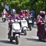 Women participate in a road safety awareness scooter rally organized by the Road Safety Club at the University of Agriculture Faisalabad in collaboration with City Traffic Police