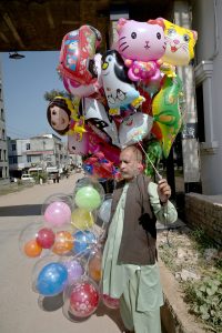 A man sells vegetable and flower seeds along the roadside at Khanna Pul