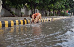 Vehicles passing through rain water accumulated on a University Road following heavy rainfall in the Provincial Capital.