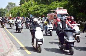 Women participate in a road safety awareness scooter rally organized by the Road Safety Club at the University of Agriculture Faisalabad in collaboration with City Traffic Police